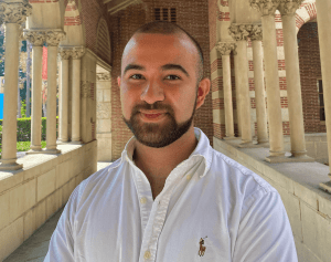 headshot of emanuel in front of columns